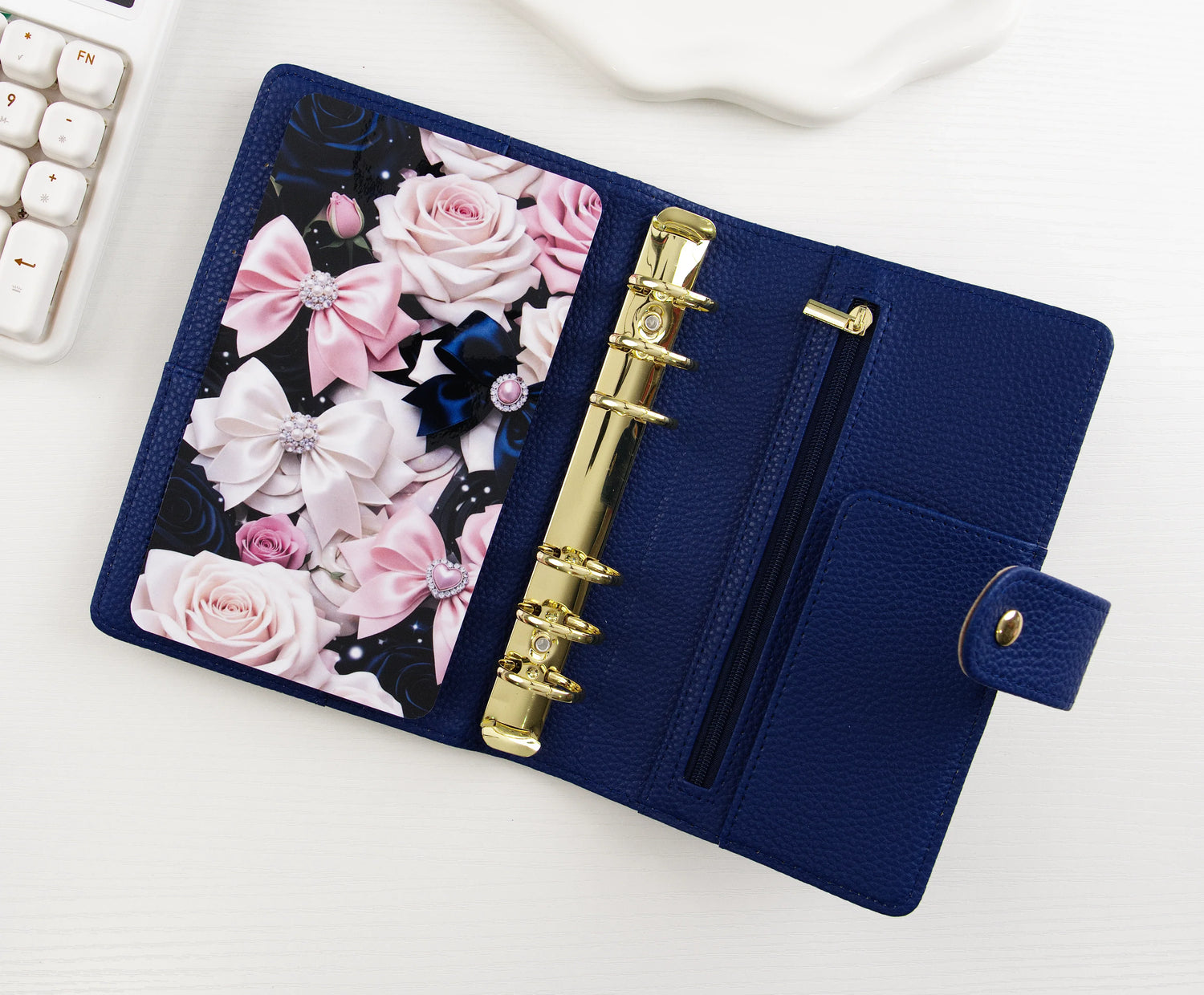 Three 2026 yearly calendar dashboard inserts displayed overlapping, featuring minimalist design with 12-month grid layout in navy, gray, and dusty blue color options, styled on white background with plant accent