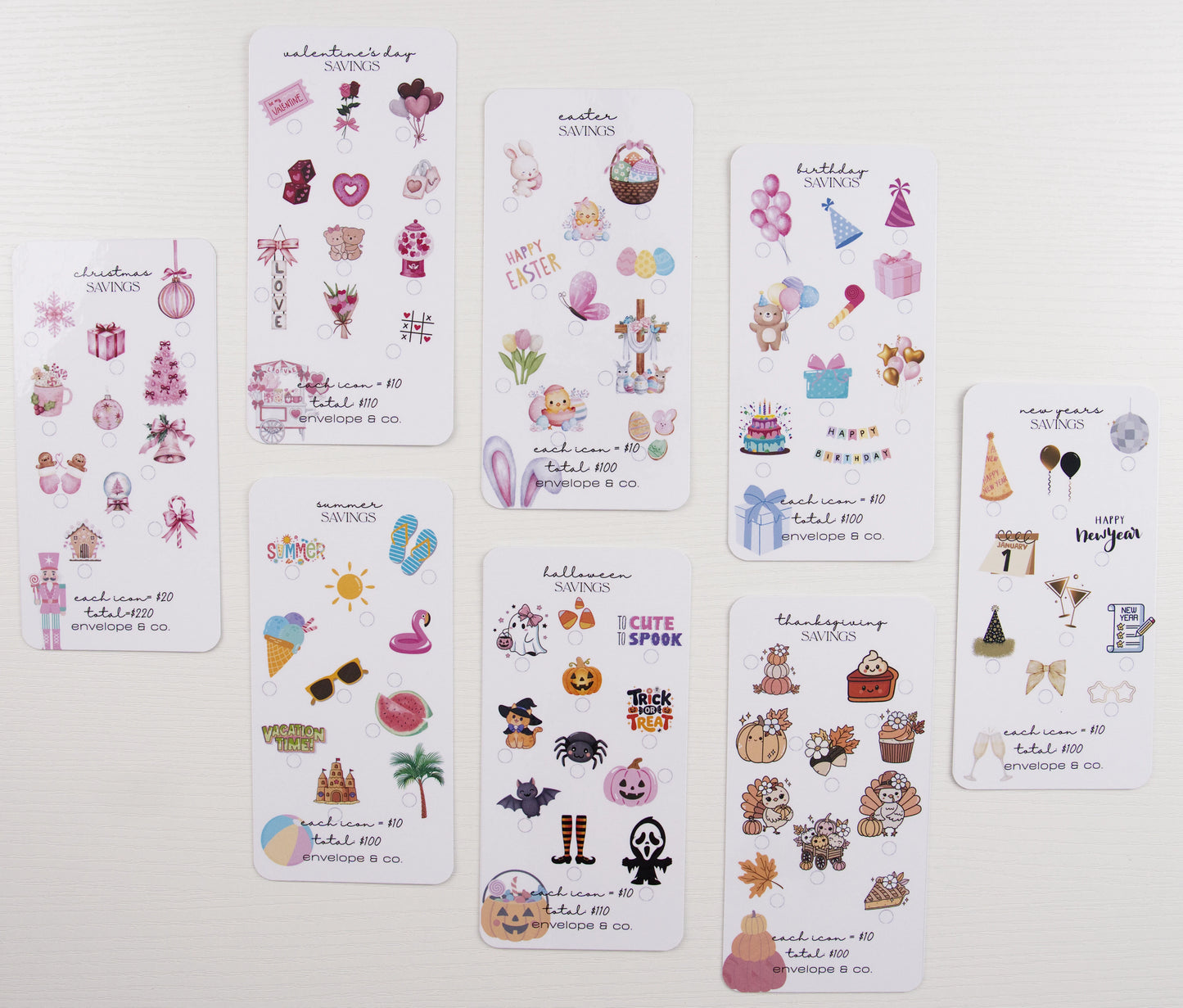 Eight seasonal savings challenge inserts displayed flat: Christmas, Valentine's Day, Easter, Summer, Birthday, Halloween, Thanksgiving, and New Year's, each featuring colorful themed icons with $100-$220 goals