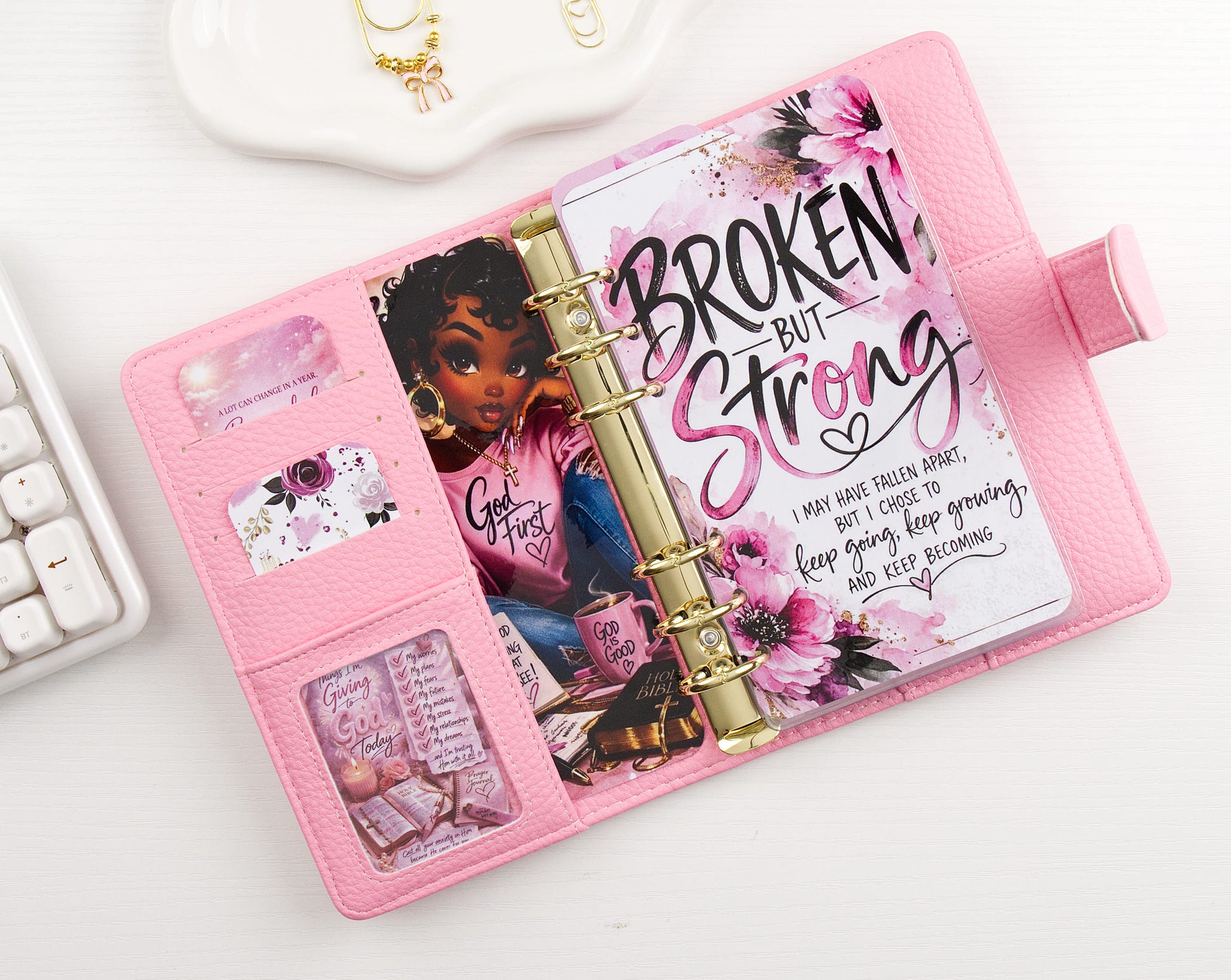 Pink binder with motivational quote and character illustration binder decor on a white surface