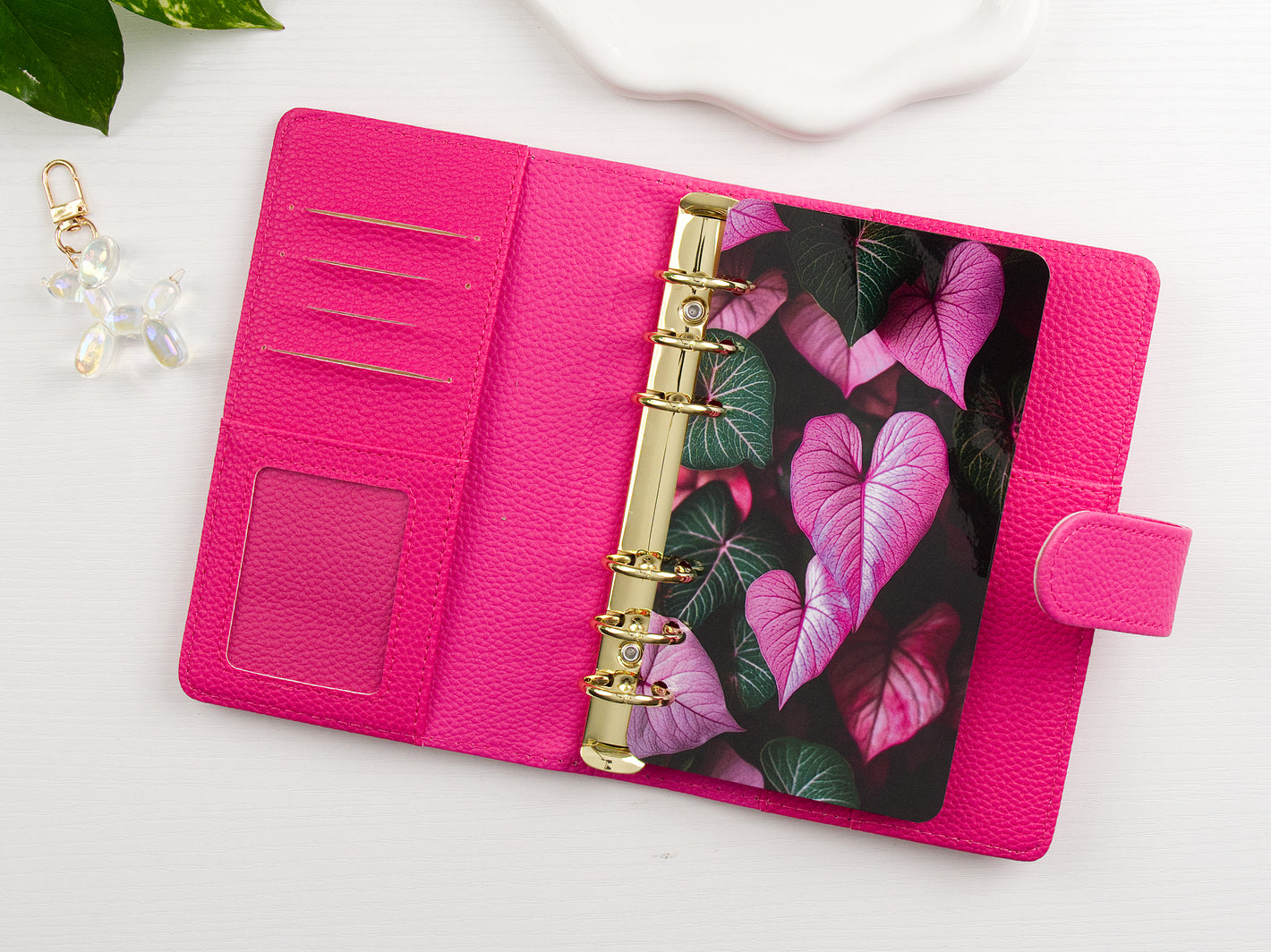 Pink binder with floral design dashboard on a white surface