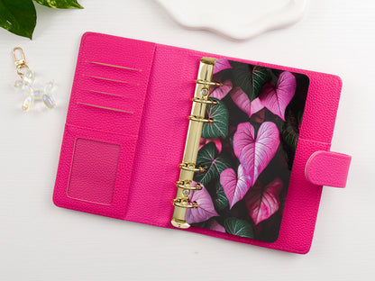 Pink binder with floral design dashboard on a white surface