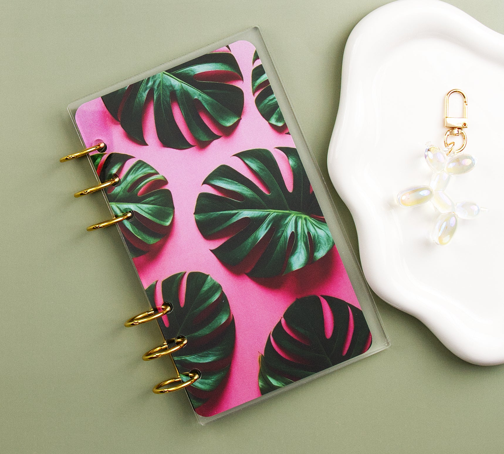 Dashboard with tropical leaf design on a green surface next to a charm