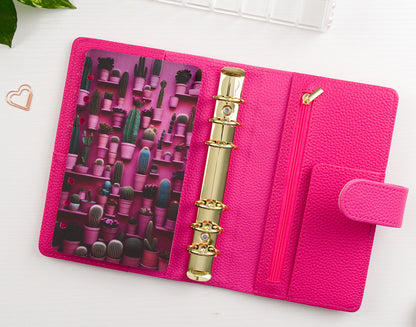 Pink binder with gold rings and cactus-themed design on a white background