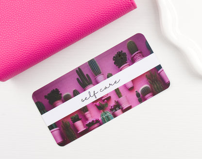 Pink binder with a cactus themed envelope insert on a white background