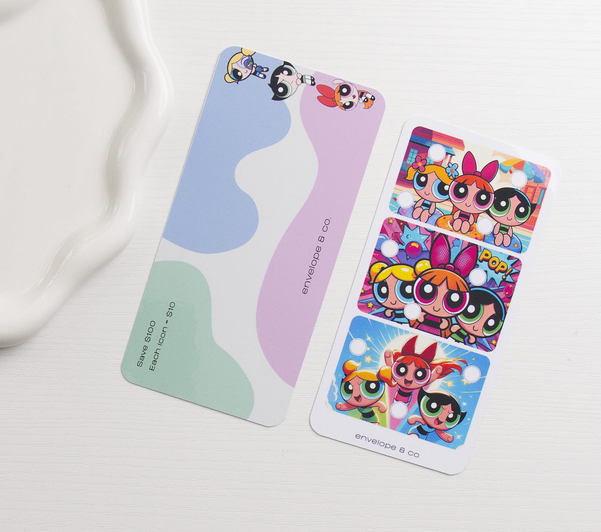 A colorful character themed savings challenge and dashboard on a white surface next to a white dish.