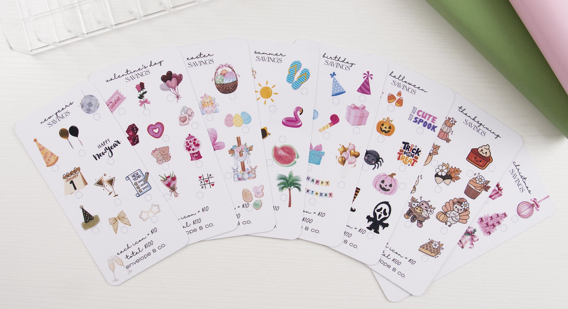 Holiday savings challenge bundle featuring eight seasonal inserts fanned out: New Year's, Valentine's Day, Easter, Summer, Birthday, Halloween, Thanksgiving, and Christmas, each with themed icons and $100-$110 goals