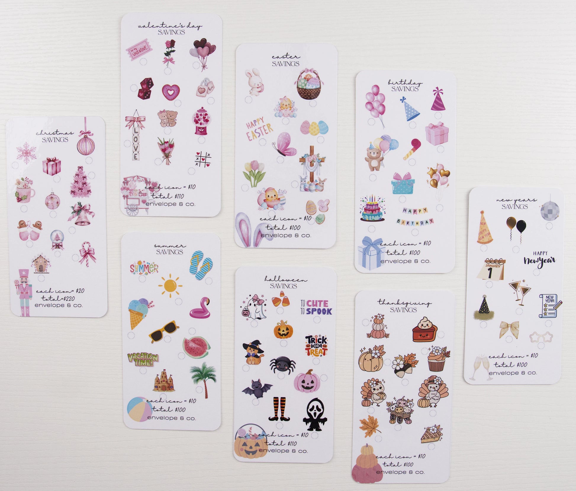Eight seasonal savings challenge inserts displayed flat: Christmas, Valentine's Day, Easter, Summer, Birthday, Halloween, Thanksgiving, and New Year's, each featuring colorful themed icons with $100-$220 goals