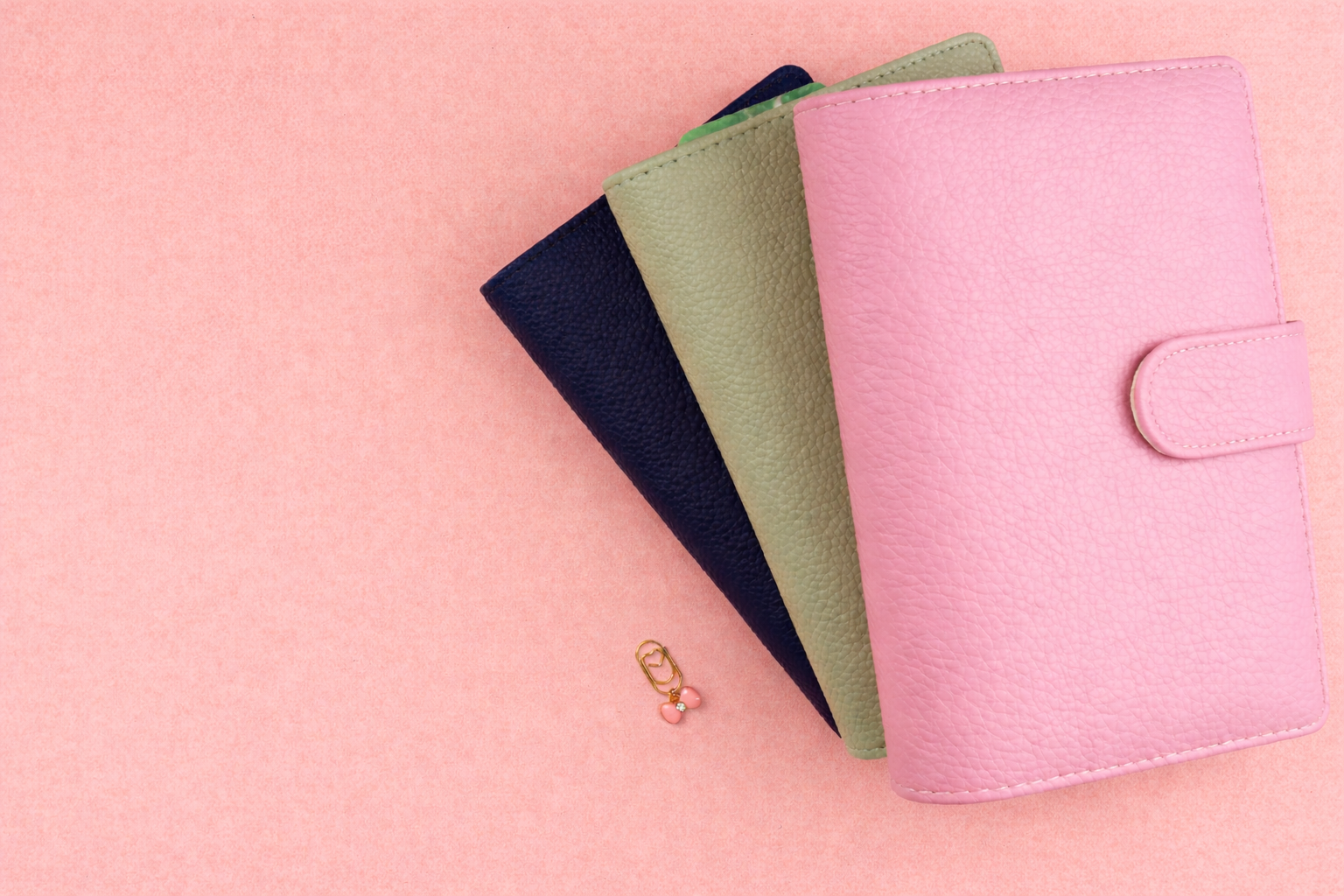 3 binders on pink background