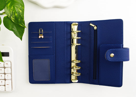 Blue binder with gold binding on a white surface