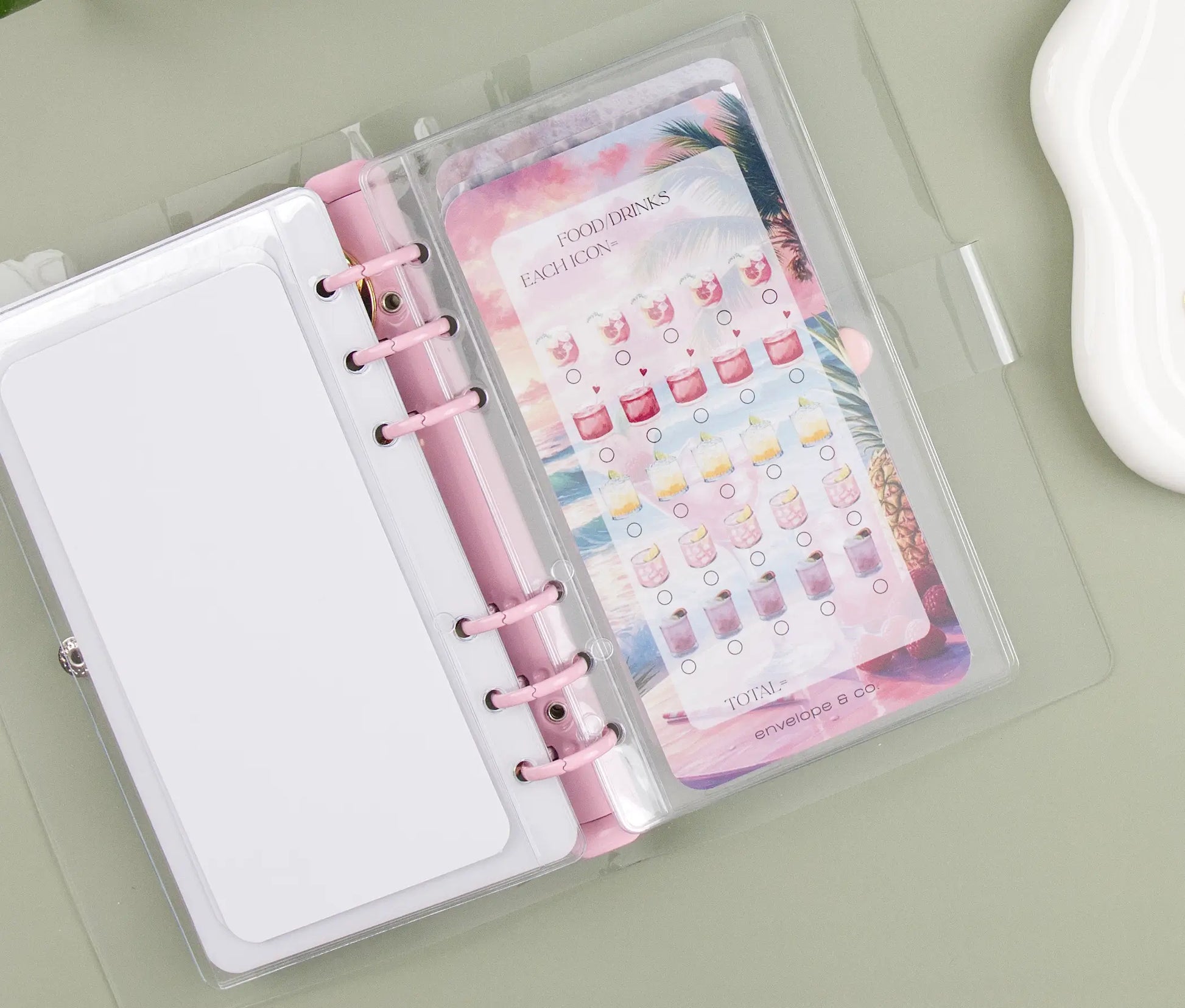 Binder bundle savings challenge with a floral design on a light green surface