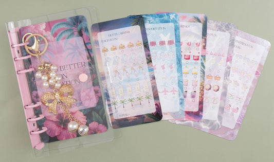 Binder bundle with a pink and floral design on a green background