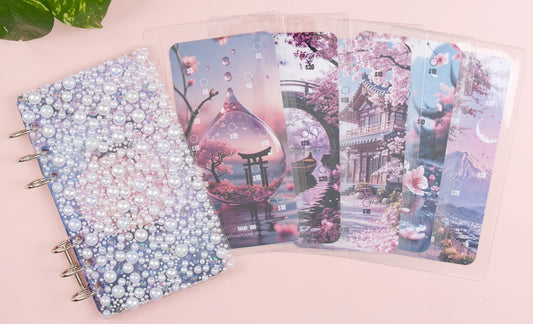 Set of savings challenges with cherry blossom temple designs on a pink surface.