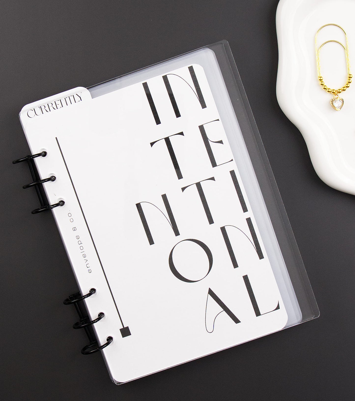 Binder with 'INTENTIONAL' design on a dark surface