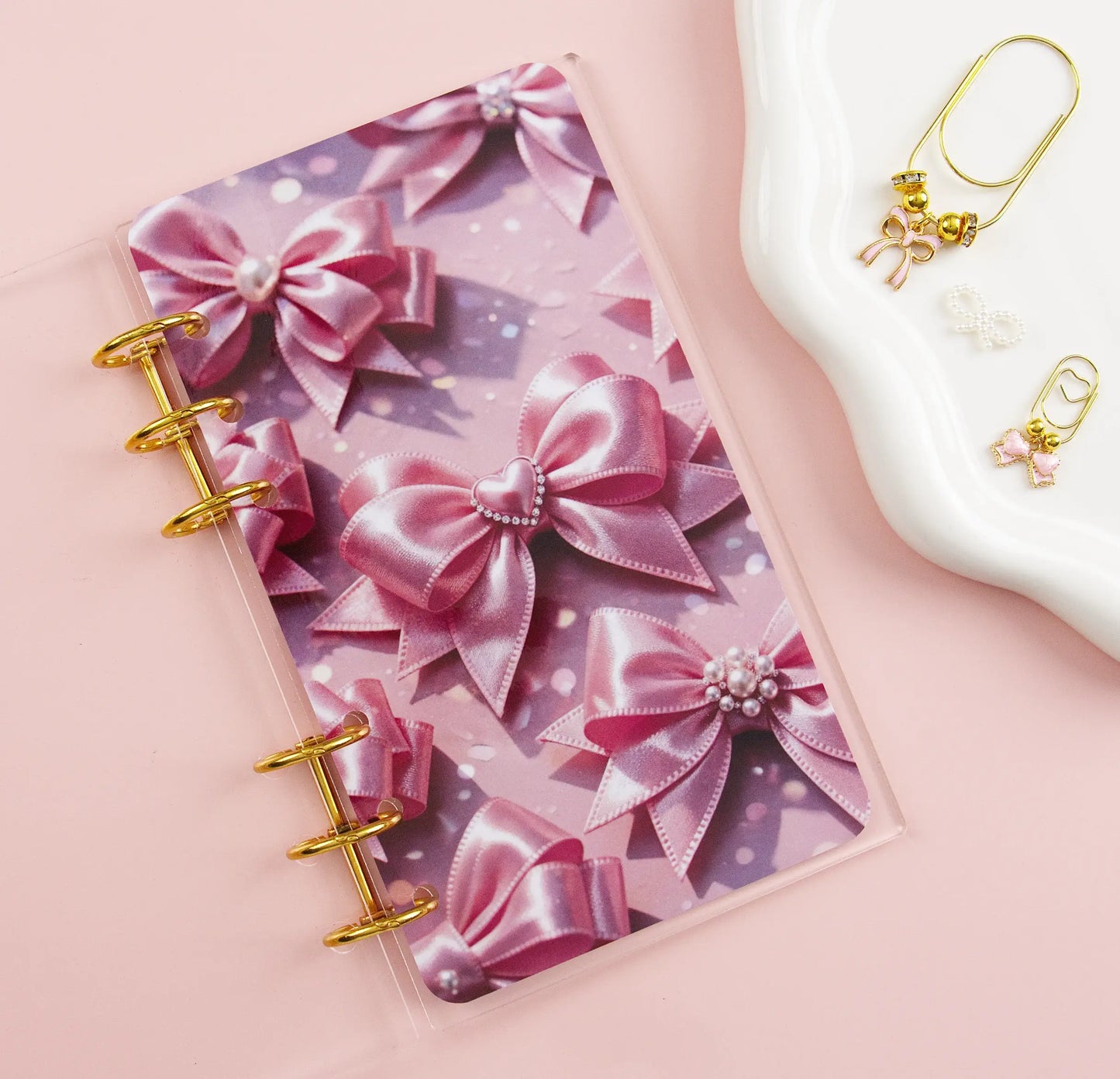 Clear binder with pink bow design on a pink background