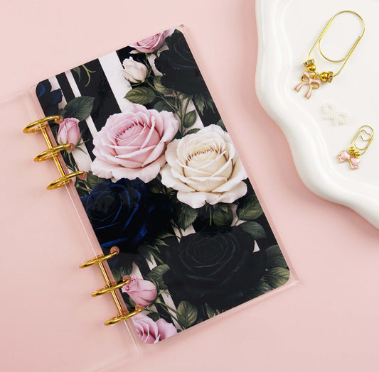Clear binder with floral dashboard with gold rings on a pink background