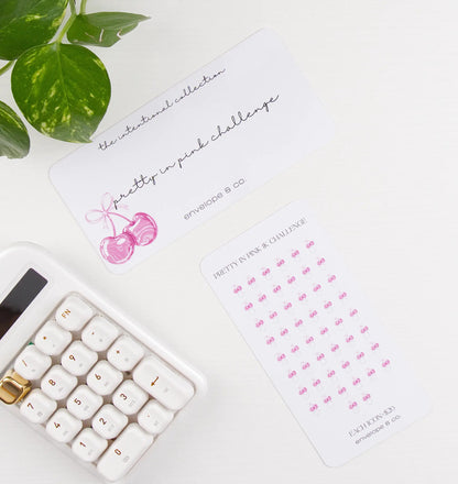Desk setup with a calculator, plant, and cherry-themed savings bundle on a white surface
