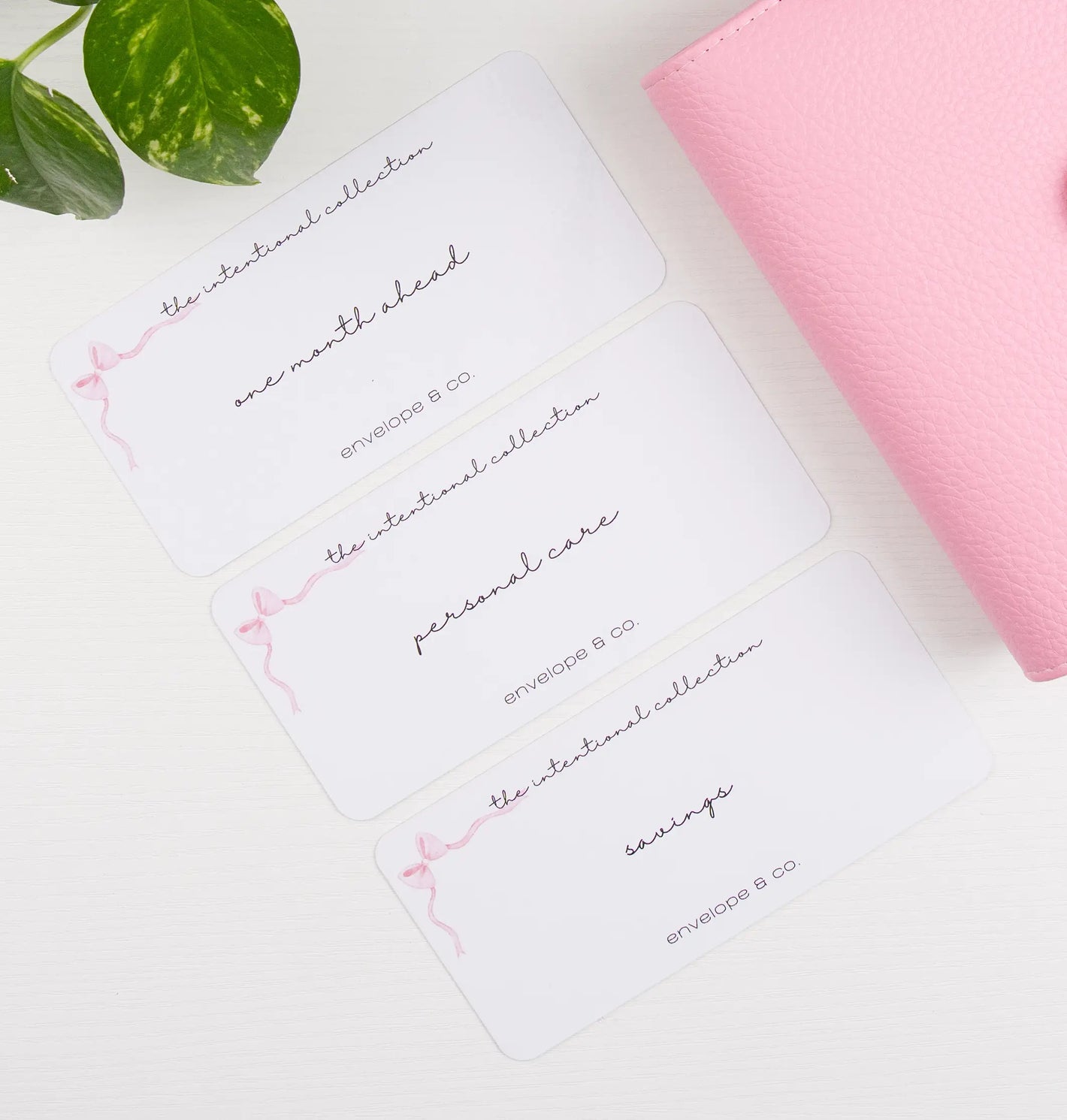 Binder with envelope inserts with cursive text on a white surface.