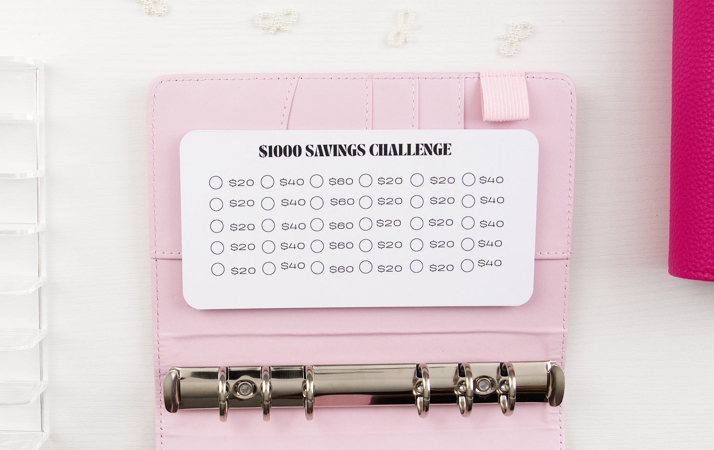Pink planner with a '52 Week Savings Challenge' card on a white background