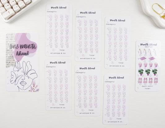 Set of savings trackers with floral designs on a white surface
